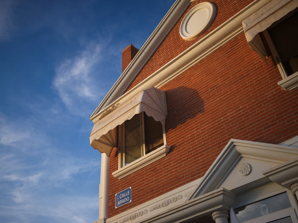 Red brick and an awning beneath the sky
