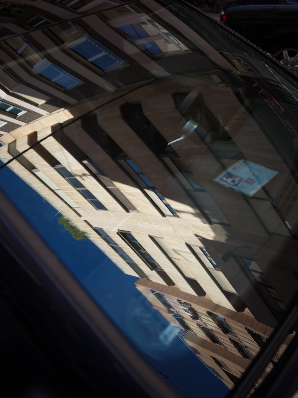 The street reflected in a car window